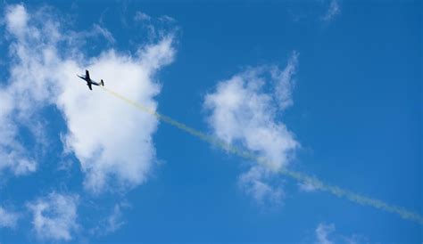 Premium Photo | Plane with colorful trail in the sky