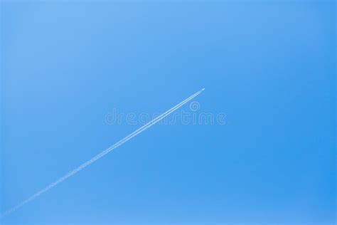 The Trail from the Flying Plane on a Blue Sky Stock Photo - Image of aeroplane, airplane: 92059796