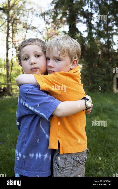 Two boys hugging Stock Photo - Alamy