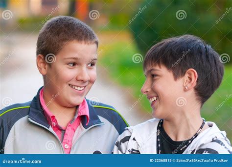 Two Teenage Boys Laughing And Kidding In Park Royalty Free Stock Photo - Image: 22368815