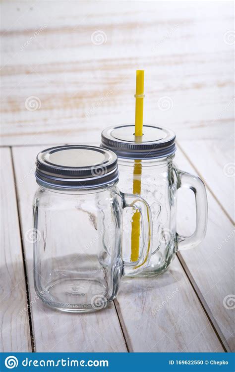 Empty Glass Mason Jar with Handle and Drinking Straw Isolated on Wood White Background Stock ...