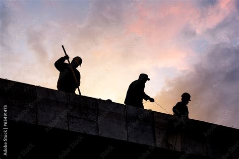 Construction workers silhouette in sunset Stock Photo | Adobe Stock