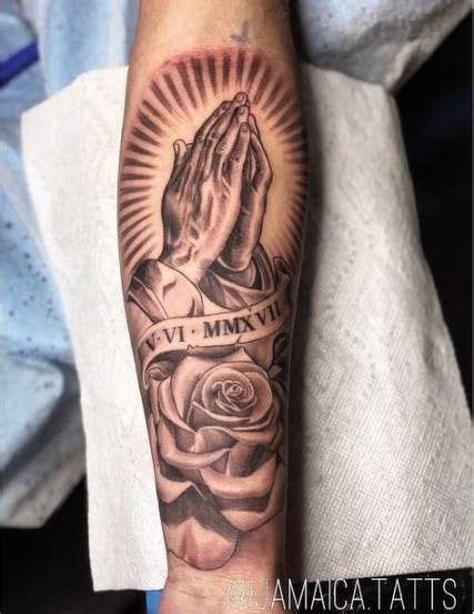 Forearm prayer hands tattoo with roses on Stylevore