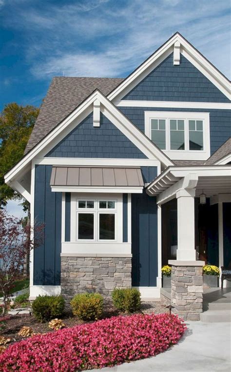 a house with blue siding and white trim on the front door is pictured in this image