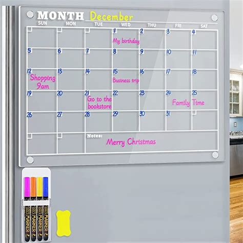 a magnetic dry eraser calendar is shown on the wall next to a marker board