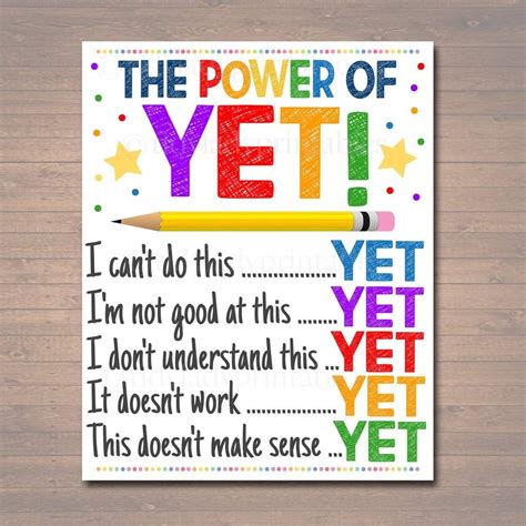 the power of yet poster is displayed on a wooden table with a pencil in it