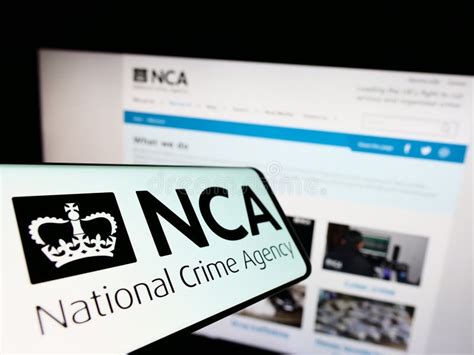 Mobile Phone with Logo of British National Crime Agency (NCA) on Screen in Front of Website ...