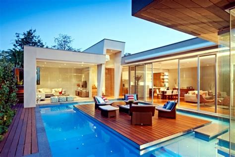 Modern House in Canterbury - A wooden deck by the pool – Ofdesign