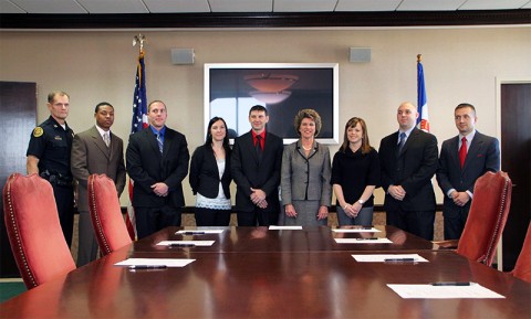 (L-R) Chief Al Ansley, Marvin Johnson, Jeremy Fowler, Kellie Belgarde, Jason Kurtich, Mayor Kim McMillan, Lacey Newton, Jonathan Spoon, and Jessie Zumbro. (Photo by CPD-Jim Knoll)