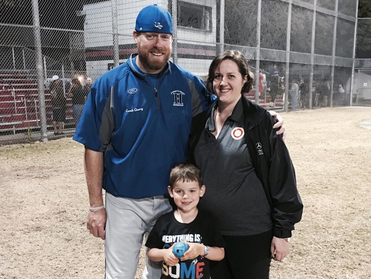 Heritage baseball coach Rob Querry poses with wife Julia and son Brady after she used a blue baseball to tell him he'd be having a son.