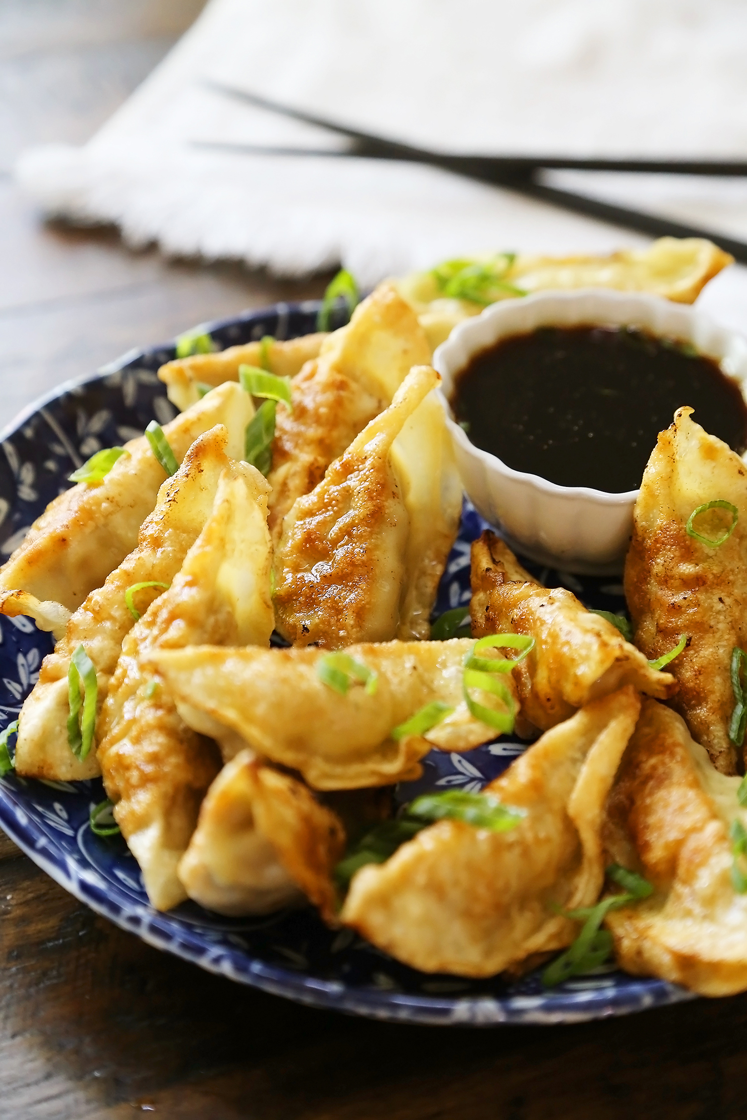 Easy Asian Dumplings with Soy-Ginger Dipping Sauce - Crispy, tender steamed potstickers, made easily in one skillet! thecomfortofcooking.com