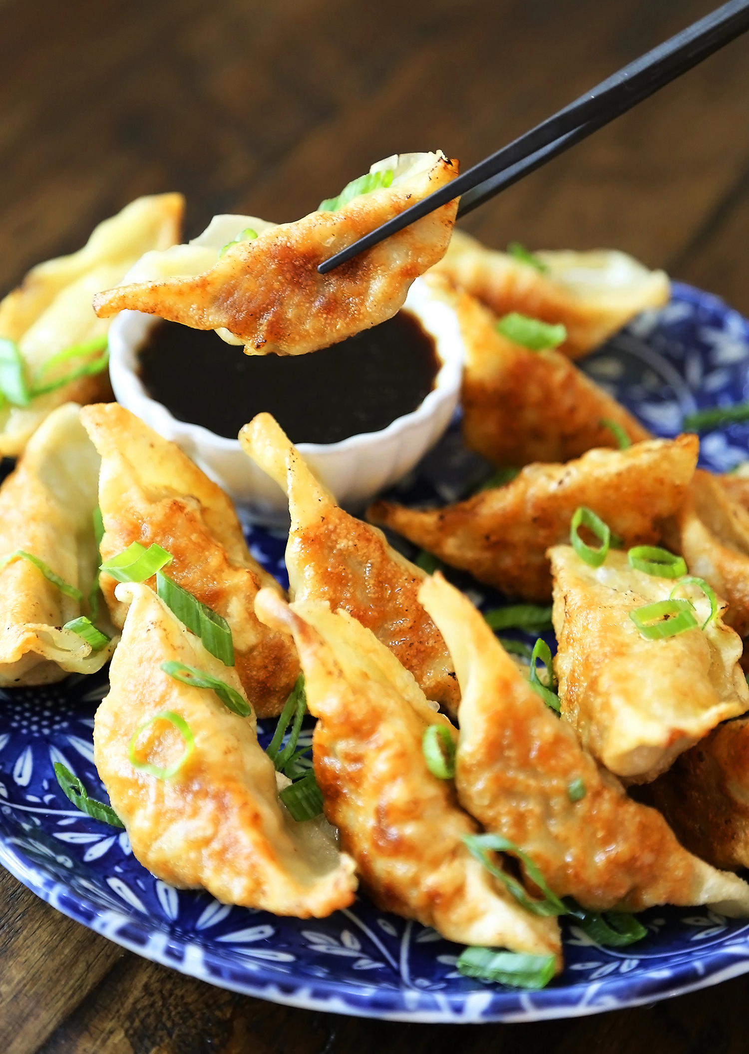 Easy Asian Dumplings with Soy-Ginger Dipping Sauce - Crispy, tender steamed potstickers, made easily in one skillet! thecomfortofcooking.com