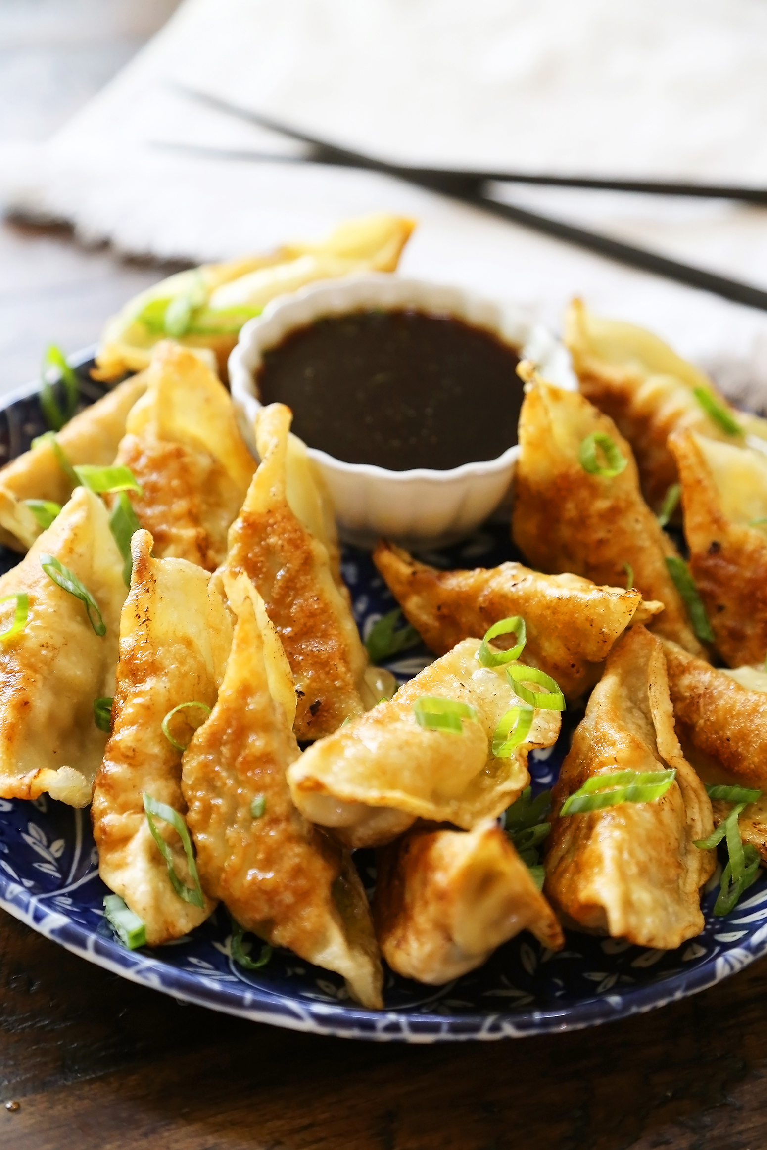 Easy Asian Dumplings with Soy-Ginger Dipping Sauce - Crispy, tender steamed potstickers, made easily in one skillet! thecomfortofcooking.com