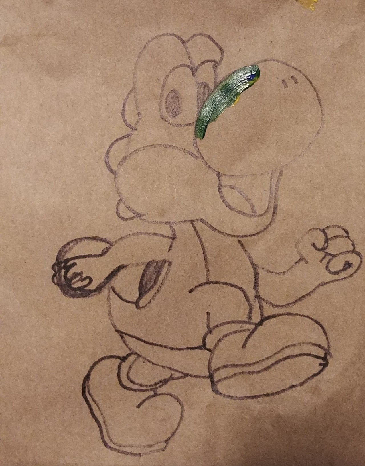 sketch of Yoshi in black permanent marker on a brown paper grocery bag