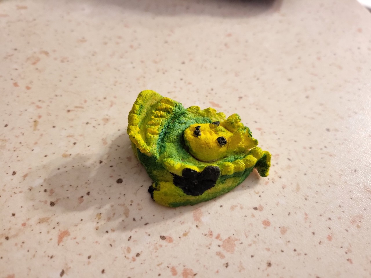 Green curled up sleeping dragon from salt dough