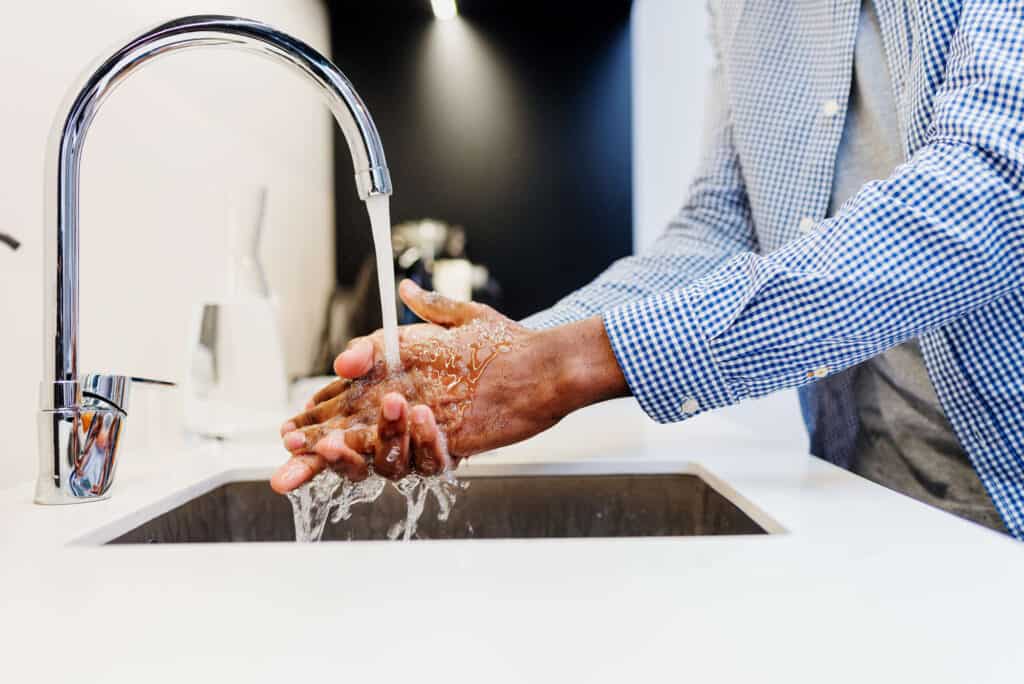 unrecognizable african man washing his hands at th 2022 08 16 18 26 41 utc