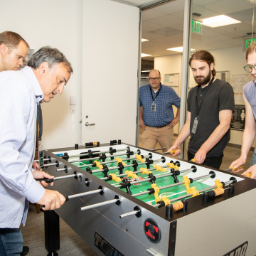 Academia staff playing Foosball