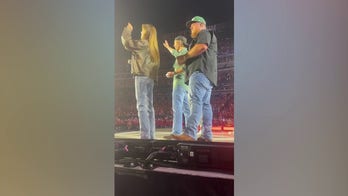 Luke Combs, actor Glen Powell chug a beer during country star's concert