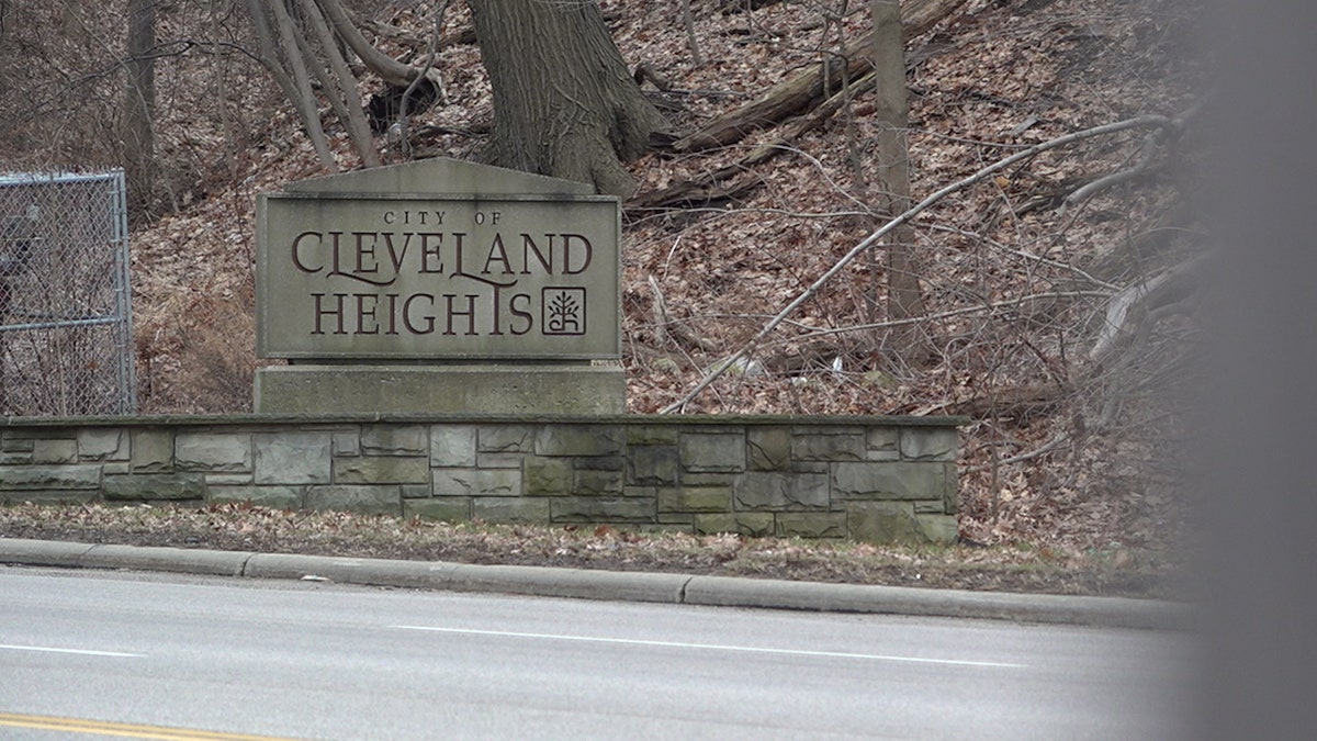 A stone sign along a road side welcoming people to Cleveland Heights