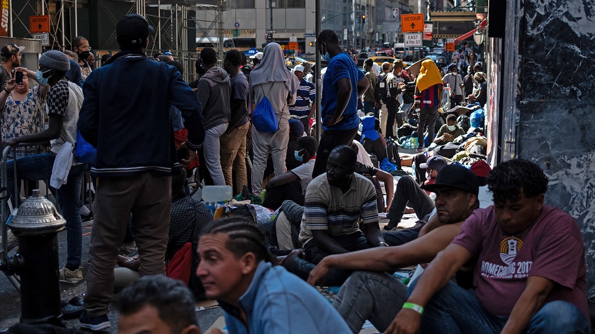 Migrants gather outside the Roosevelt Hotel in New York City on Aug. 2, 2023, where dozens of recently arrived migrants have been camping out as they try to secure temporary housing.