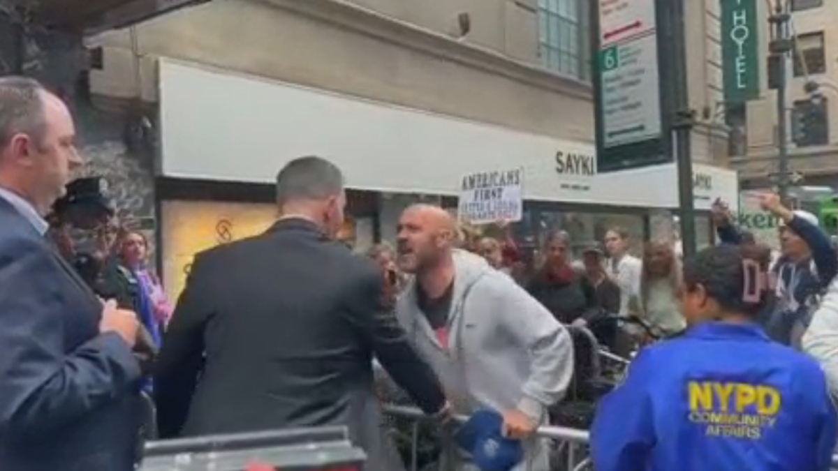 Protester shouts after news conference on NYC migrant crisis