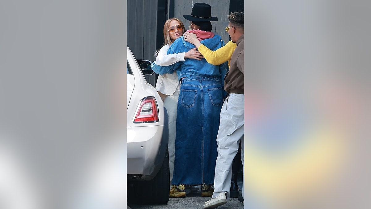 Jennifer Lopez hugs dance crew outside studio in LA.