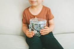 Child holding jar of saved money