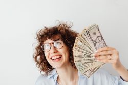 Woman fanning herself with money