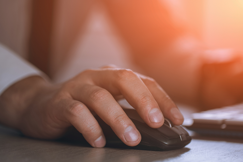 Hand on a computer mouse.