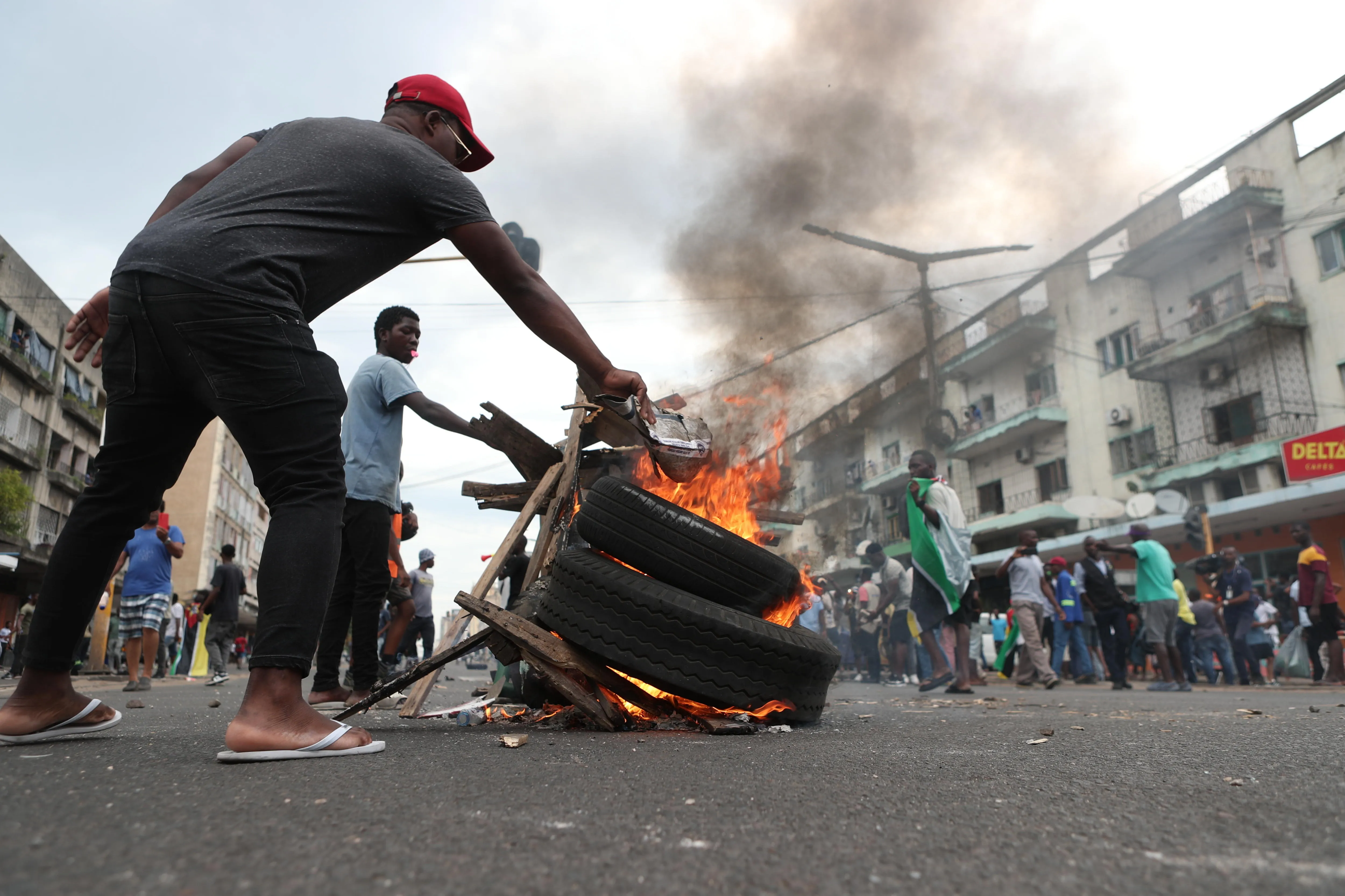 Demonstrators burn tires during a protest against the electoral process in Maputo, Mozambique, 27 N