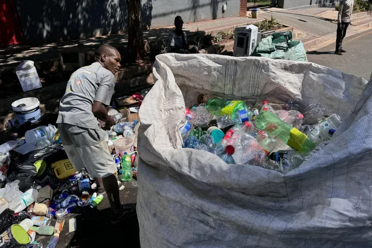 A plastic waste collector in a street in Johannesburg, South Africa, November 26. (Photo by Joséph