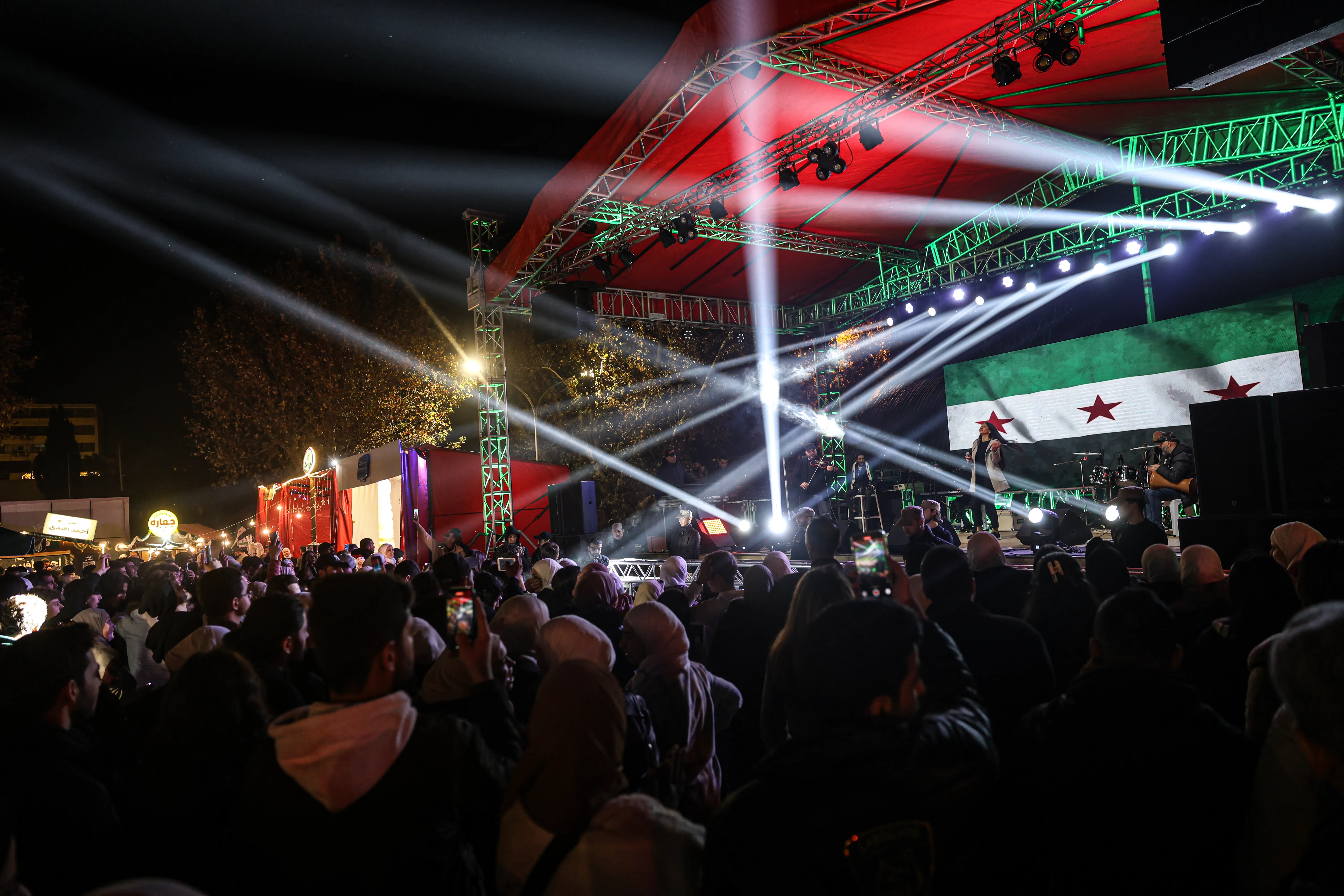 Syrian Christians and others dance during a concert as they celebrate Christmas at the Damascus Chr