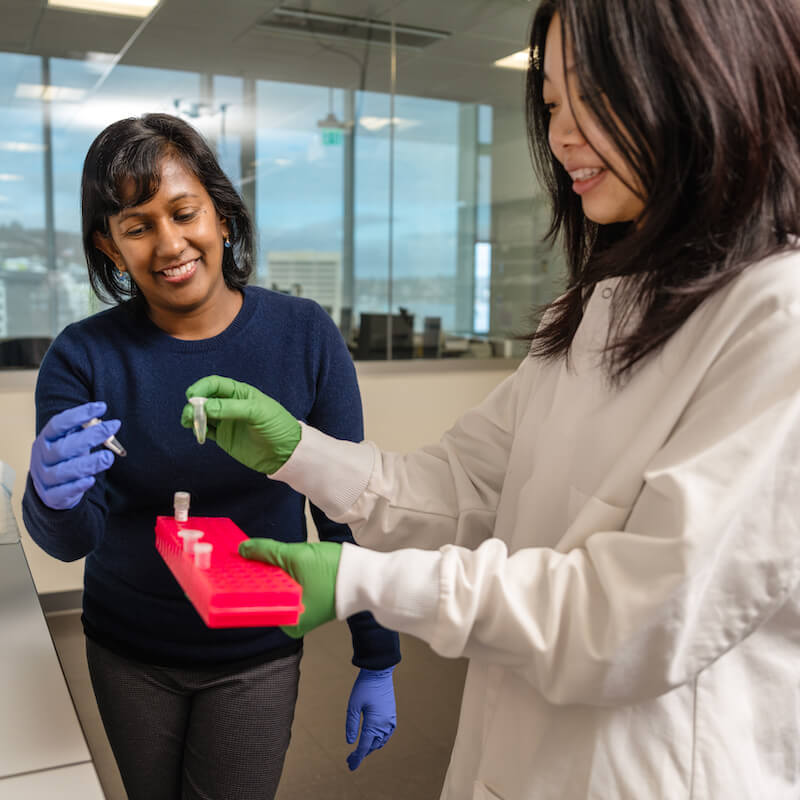 Two researchers in the lab looking at samples