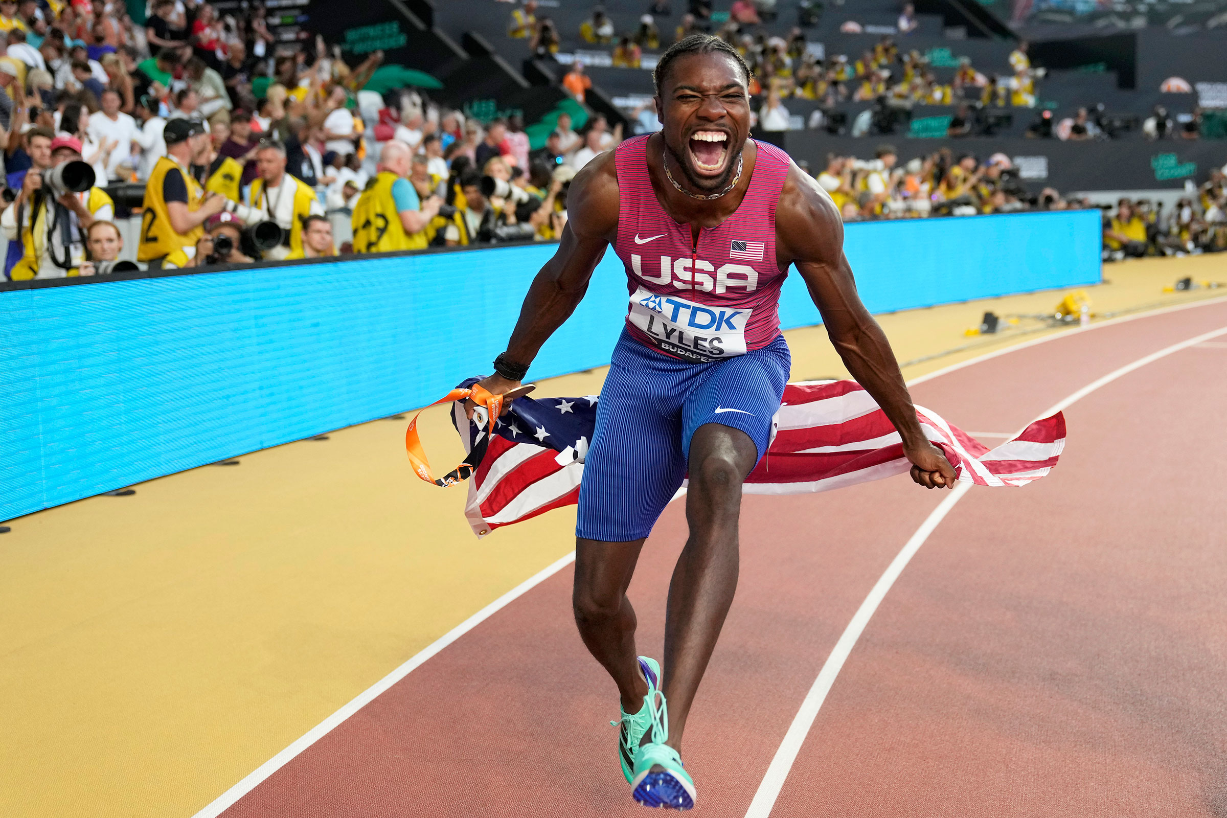 Lyles celebrates winning gold in the 100 m at the 2023 World Athletics Championships in Budapest