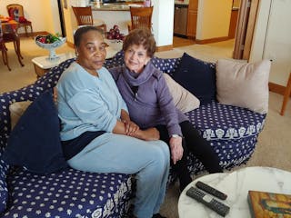 Caregiver Vickey Korlewala, left, with Gretta Freeman.