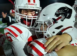 Lakeville North offensive lineman Cole Peterson, left, and defensive back Wyatt Brunello celebrate in the final moments of their game against Minneton