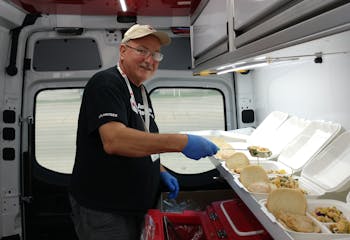 Red Cross volunteer Dave Snetsinger prepared hot meals for those affected by Hurricane Ian in Fort Myers, Fla.