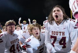 Lakeville South players including center Brecken Klein (74)  celebrate after defeating Stillwater 37-14 in a Class 6A quarterfinal game.