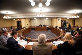 Members of the State Legislative Audit Commission listen on June 13 as Special Reviews Director Katherine Theisen and Legislative Auditor Judy Randall