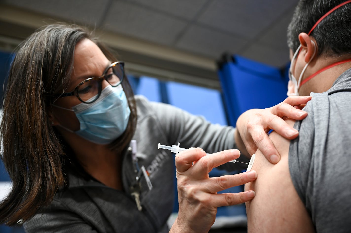 Kari Cline, a nurse and manager with North Memorial Team Member Occupational Health, administered a COVID-19 vaccination to a doctor at North Memorial Health Hospital.