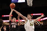 New Life Academy's Colton Hendricks (34) attempts to block Tysen Grinde's shot in the first half. Hendricks led the Eagles' scoring with 13 points. Ph