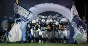 Members of the St. Francis football team take the field in St. Francis, Minn. on Wednesday October 19, 2022.