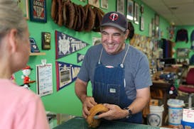 Jimmy Lonetti talks with a customer about a catchers mitt at his shop, D&J Glove Repair, in south Minneapolis.