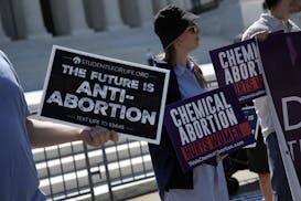 Anti-abortion protesters demonstrate outside the Supreme Court in Washington on Thursday. The Supreme Court unanimously rejected a bid to sharply curt