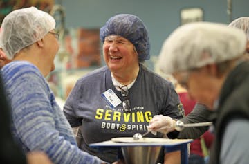 Volunteers gathered at the workstation tables at Feed My Starving Children in Coon Rapids.