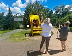 A giant Adirondack chair provides a photo opportunity in downtown Taylors Falls, Minn., near the gateway to the Taylors Falls River Walk.