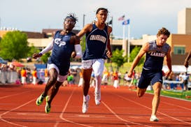 Richlu Tudee, left, of Champlin Park finishes first in the 100m dash during the Minnesota Class 3A track and field state finals.