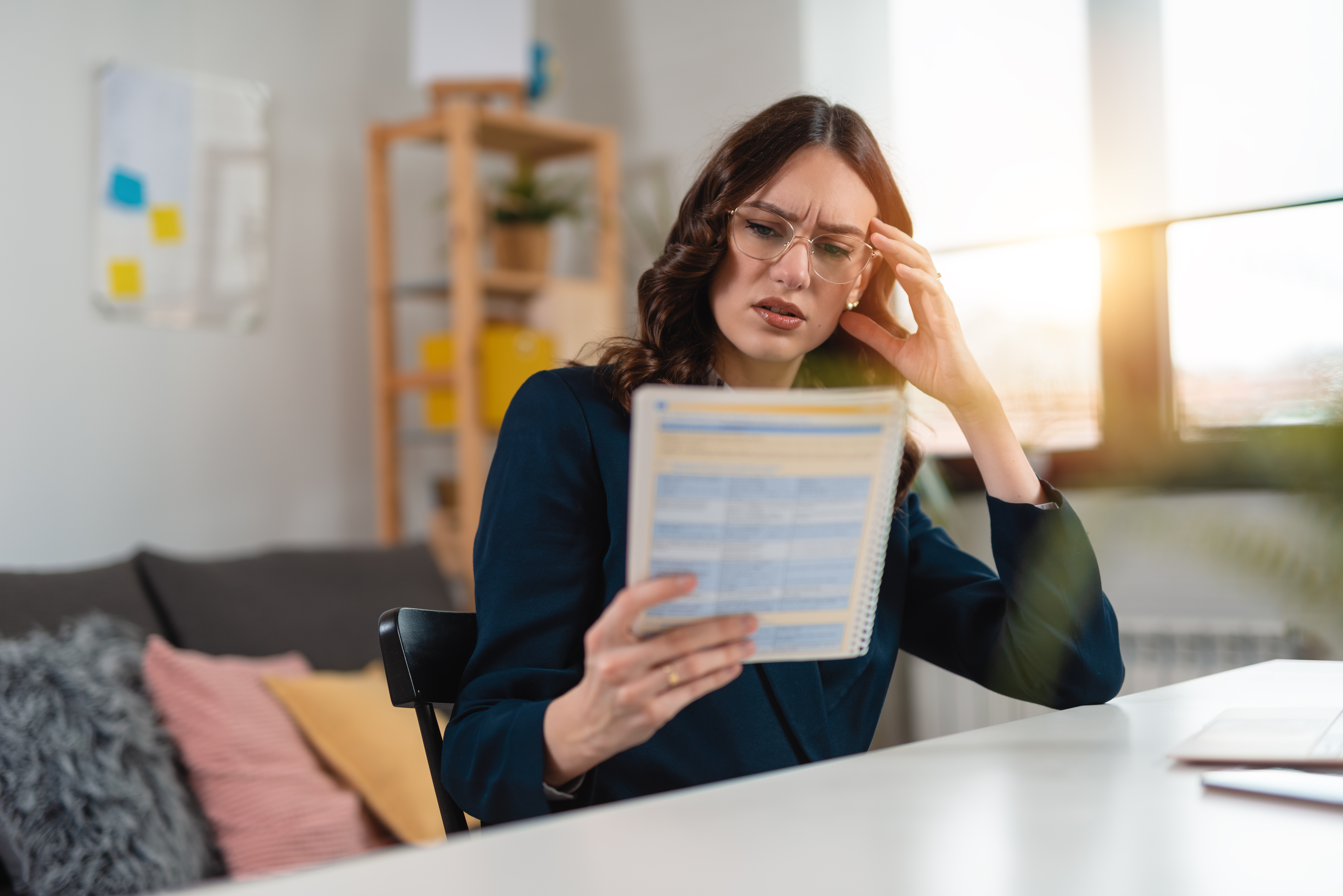 Woman looking at paper frustrated 