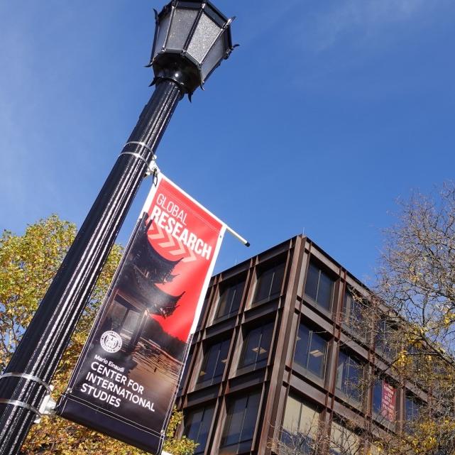 		Black lamp post holding up a red poster that says Global Research
	