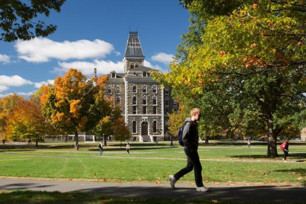 Stone building on a college campus, seen from across a green lawn